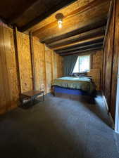 Unfurnished bedroom with beamed ceiling