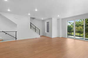 Unfurnished living room with light wood-type flooring