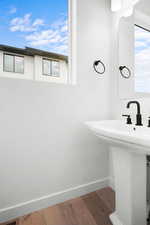 Bathroom with hardwood / wood-style flooring and sink