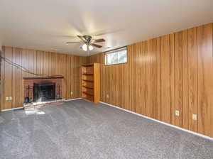 basement family room with high ceilings and fireplace. New carpet