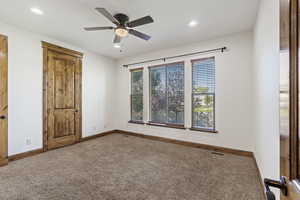 Unfurnished bedroom with carpet and ceiling fan