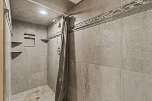 Bathroom featuring a shower with curtain