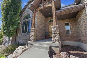 Entrance to property featuring covered porch