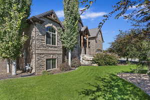 View of side of property with a lawn