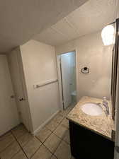 Bathroom with bathing tub / shower combination, tile patterned flooring, and vanity