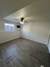 Spare room with ceiling fan and dark hardwood / wood-style floors