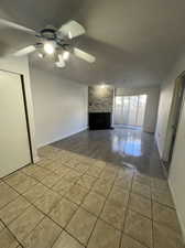 Unfurnished living room with light hardwood / wood-style flooring, ceiling fan, and a brick fireplace