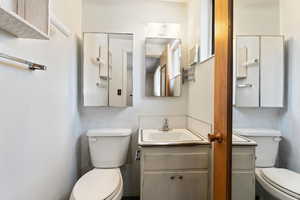 Master half bathroom featuring vanity and toilet