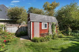 View of shed featuring a lawn