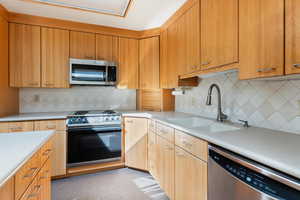 Kitchen with stainless steel appliances, tasteful backsplash, and sink