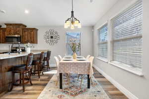 Dining space with a chandelier and hardwood / wood-style flooring