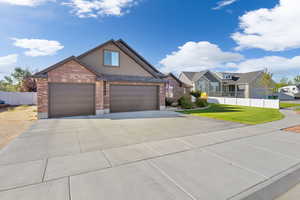 View of front of house featuring a front lawn and a garage