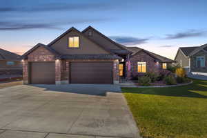 View of front of property with a lawn and a garage