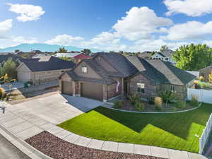 View of front of house with a front yard, a mountain view, and a garage