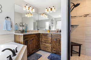 Bathroom featuring vanity and shower with separate bathtub