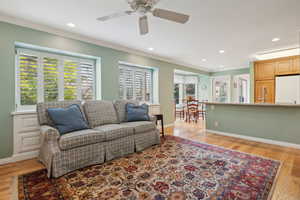 Family Room featuring built-in drawer storage and plantation shutters