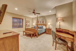 Bedroom featuring ceiling fan and light carpet