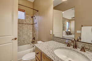 Full bathroom featuring vanity, toilet, and tiled shower / bath