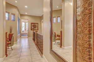 Hall featuring light tile patterned floors