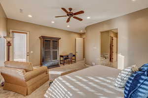 Bedroom featuring ceiling fan and light colored carpet