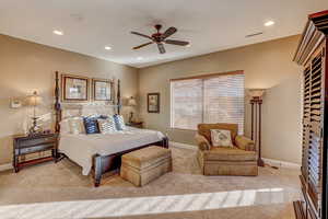 Carpeted bedroom with ceiling fan