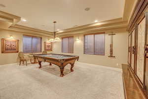 Recreation room featuring dark colored carpet, a raised ceiling, and billiards