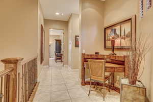 Hallway with light tile patterned floors