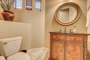 Bathroom featuring vanity, toilet, and tile patterned floors