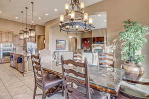 Dining area featuring an inviting chandelier, sink, and light tile patterned floors