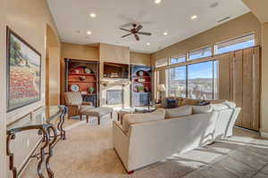 Living room with light carpet and ceiling fan