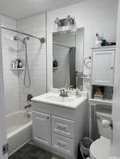 Full bathroom featuring vanity, shower / tub combo, and toilet