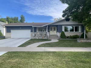 View of front facade with a front yard and a garage