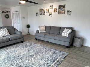 Living room with ceiling fan and wood-type flooring