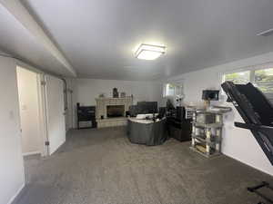 Basement with carpet and a brick fireplace