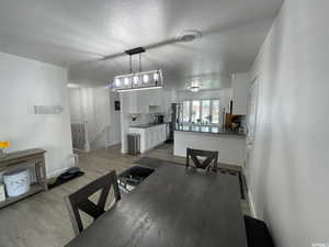 Dining area featuring light hardwood / wood-style flooring, a textured ceiling, and sink