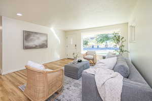 Living room with oversized picture window & view of mountains