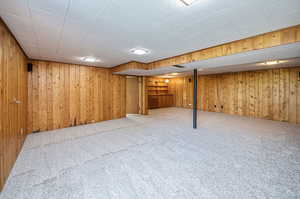 Huge family room with new carpet and real wood paneling