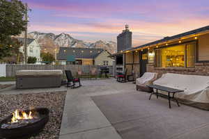 Backyard patio with hot tub and fire pit