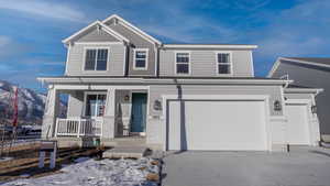 View of front of house with a porch, a garage, and a mountain view