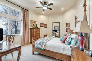 Bedroom with light carpet and ceiling fan