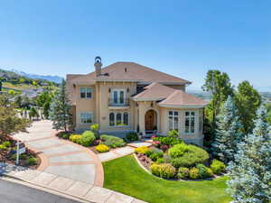 Mediterranean / spanish home featuring a mountain view and a front lawn