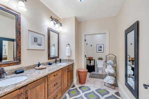 Bathroom featuring vanity, tile patterned flooring, and toilet