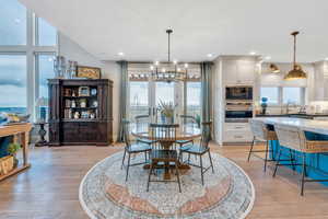 Dining space featuring a chandelier, light hardwood / wood-style floors, and sink