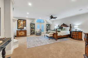 Bedroom featuring ceiling fan, light colored carpet, and french doors