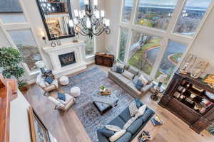 Living room with a notable chandelier, a high ceiling, and hardwood / wood-style flooring