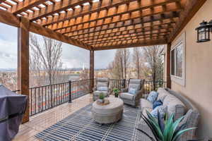 Wooden deck featuring a pergola, area for grilling, and an outdoor hangout area