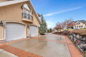 View of property exterior with a balcony and a garage