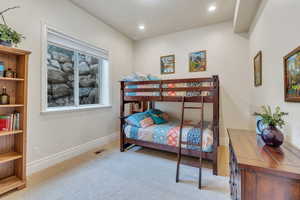 Bedroom with light colored carpet