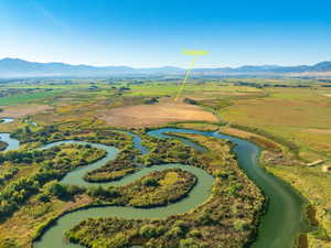 Aerial view with a water and mountain view and a rural view