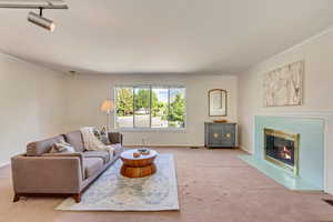 Large upper level living room with fireplace and great natural light